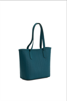 Teal handbag on a white background