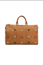 Tan travel bag with decorative patterns on a white background